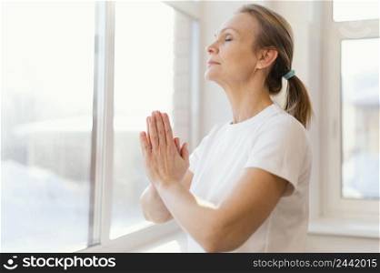 medium shot woman meditating