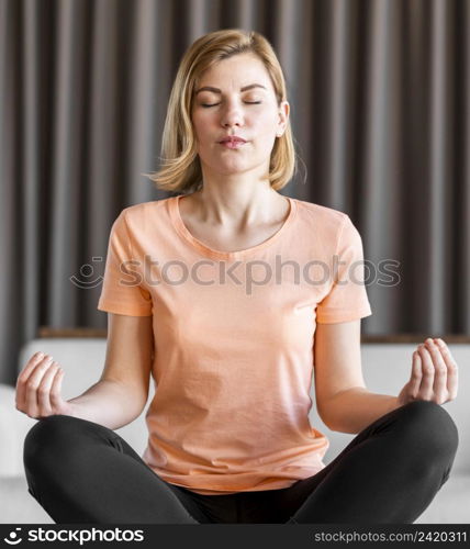 medium shot woman meditating indoors