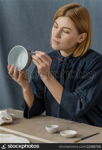 medium shot woman painting bowl
