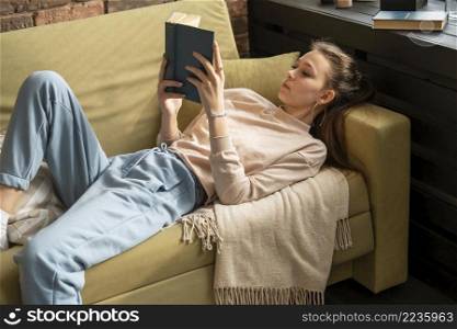 medium shot woman reading book