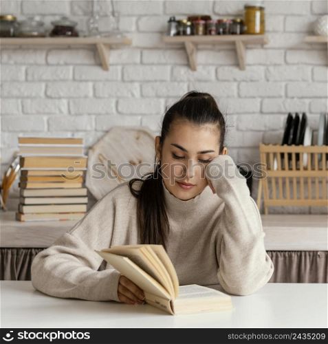 medium shot woman reading table
