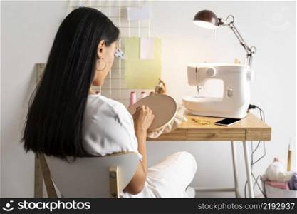 medium shot woman sewing home