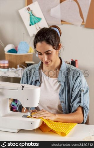 medium shot woman sewing with machine
