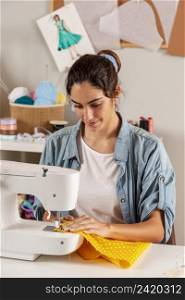 medium shot woman sewing with machine