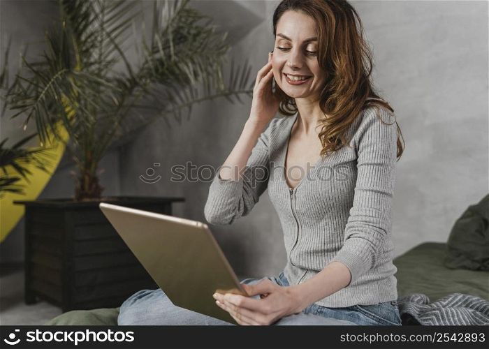 medium shot woman streaming with tablet