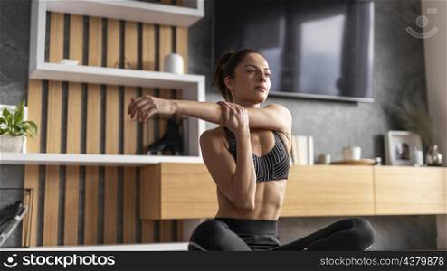 medium shot woman stretching her arm