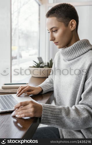 medium shot woman typing