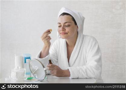 medium shot woman using serum