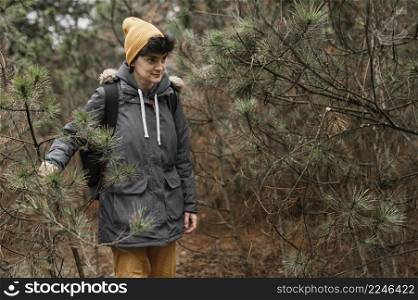 medium shot woman walking forest