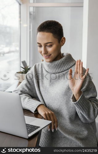 medium shot woman waving laptop