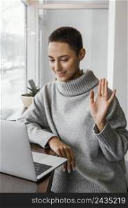 medium shot woman waving laptop
