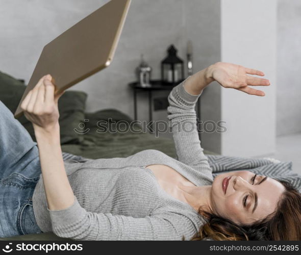 medium shot woman waving tablet