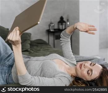 medium shot woman waving tablet