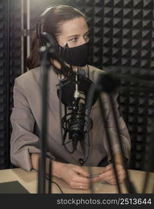 medium shot woman wearing mask radio