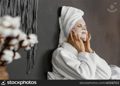 medium shot woman with moisturizing mask