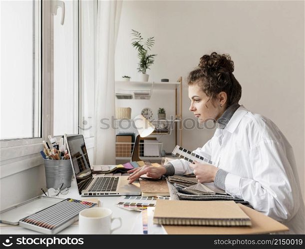 medium shot woman working with laptop