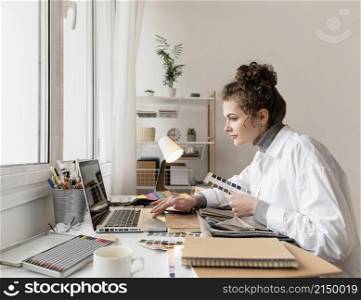 medium shot woman working with laptop