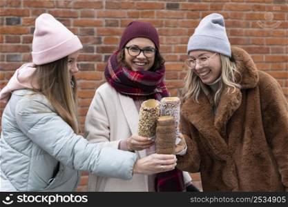 medium shot women holding chimney cakes