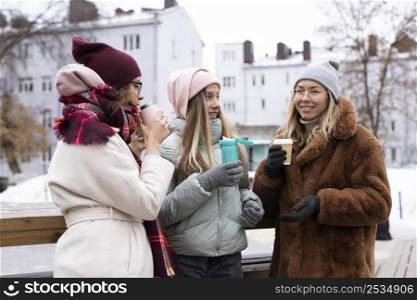 medium shot women holding coffee cups