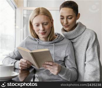 medium shot women reading together