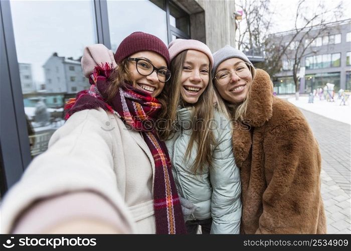 medium shot women taking selfie