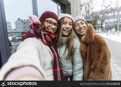 medium shot women taking selfie