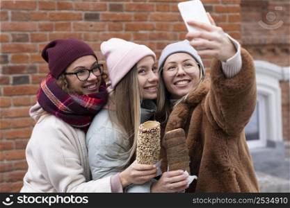 medium shot women taking selfies