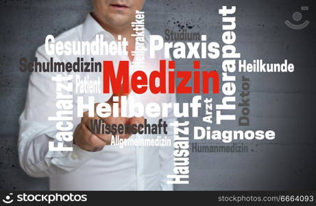 Medizin (in german Medicine) wordcloud touchscreen is operated by man.. Medizin (in german Medicine) wordcloud touchscreen is operated by man
