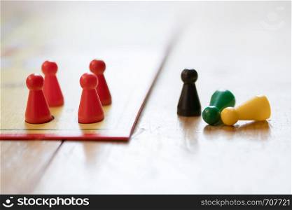 Meeples on a board, ready for playing a parlor game, ludo