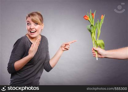 Meeting and date concept. Girlfriend on date getting bouquet of red tulips. Boyfriend hand palm giving tulips gift present to his girl.. Woman gets bouquet of tulips from man.