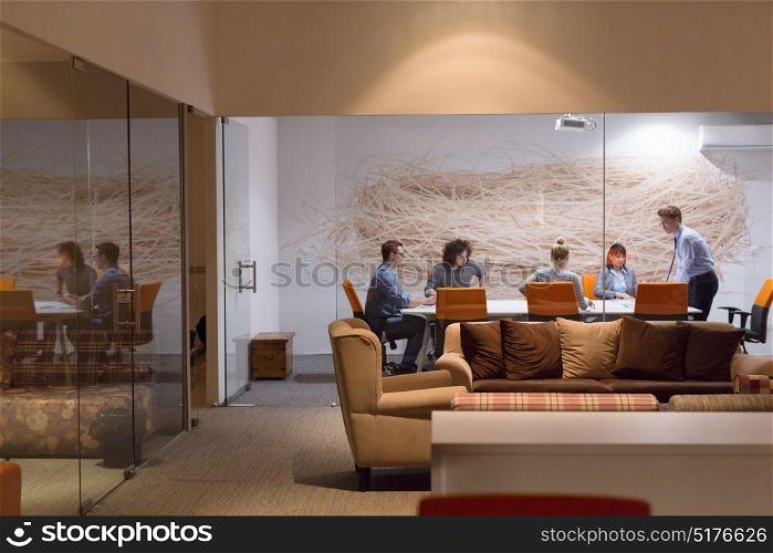 Meeting in a modern office at night