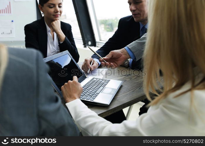 Meeting of business partners. Meeting of business partners using laptops and talking at the table