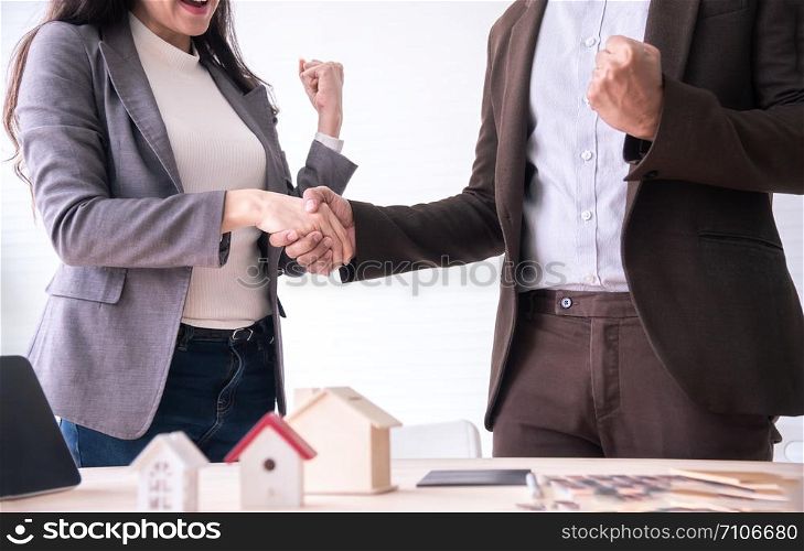 Meeting of Insurance agent and customer shaking hand after signing contract for realty purchase in office.Bank employee congratulate.Home loan approval,insurance mortgage,real estate concept.