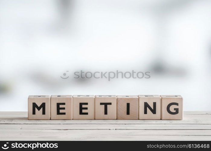 Meeting sign with wooden blocks on an office desk