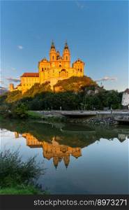 Melk, Auistria - 22 September, 2022  historic Melk Abbey in warm evening light with reflections in the calm Danube River