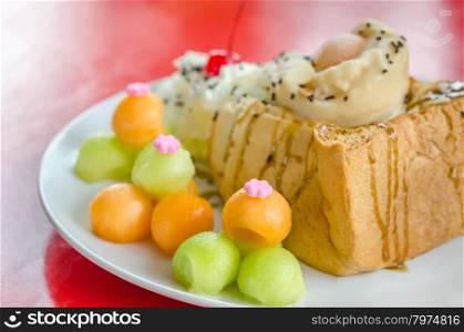 Melon toast. Honey toast topped with ice cream cantaloupe and melon on dish