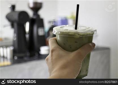 Melted iced green tea latte , stock photo