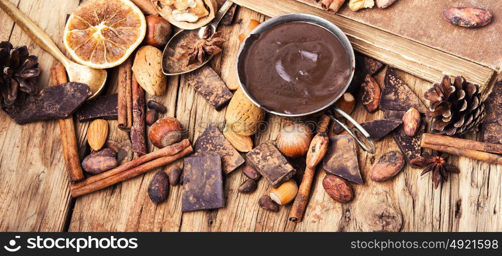 Melting chocolate,spice and nuts. Hot melting chocolate with anise,cinnamon sticks,cocoa beans and nuts