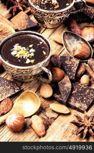 Melting chocolate,spice and nuts. Melted chocolate with spices in stylish metal cups