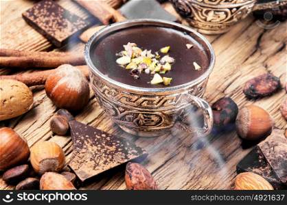 Melting chocolate,spice and nuts. Melted chocolate with spices in stylish metal cups