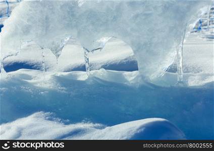 Melting glacial block of ice with icicles closeup.
