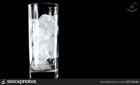 Melting ice cubes in glass