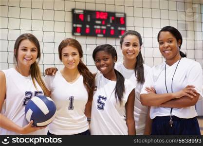 Members Of Female High School Volleyball Team With Coach