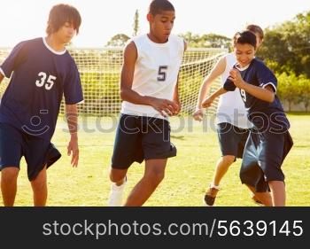 Members Of Male High School Soccer Playing Match