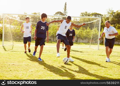 Members Of Male High School Soccer Playing Match