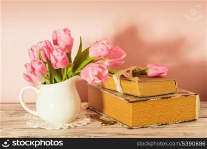 Memo still life with books, key and pink tulips