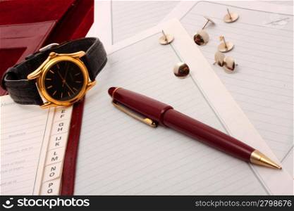 Memoranda with clock and pen.