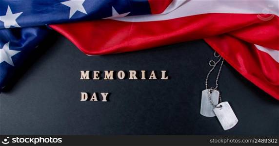 Memorial day concept. American flag and military dog tags on a black background. Remember and honor. Banner format. Memorial day concept. American flag and military dog tags on black background. Remember and honor.