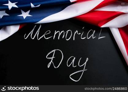 Memorial day concept. Handwritten lettering on black chalkboard and American flag. Remember and honor.. Memorial day concept. Handwritten lettering on black chalkboard and American flag.