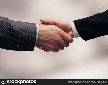 men&acute;s arms making handshake